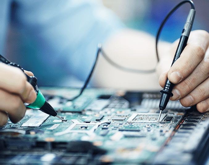 A person repairing a computer motherboard