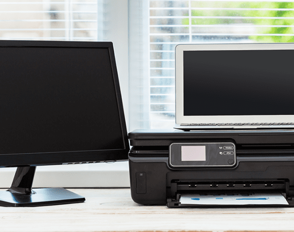 A monitor, a laptop, and a printer